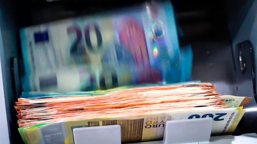Euro notes running through a banknote counter